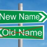 A street sign with the labels "New Name" and "Old Name" (crossed out)