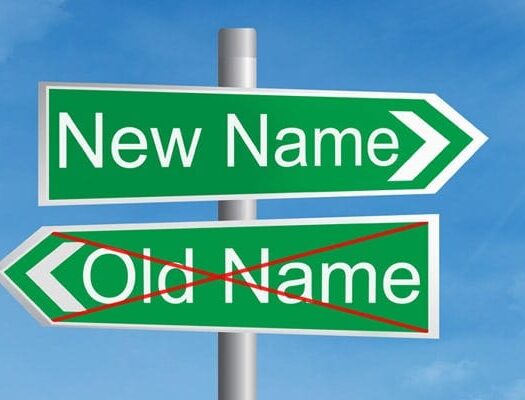 A street sign with the labels "New Name" and "Old Name" (crossed out)